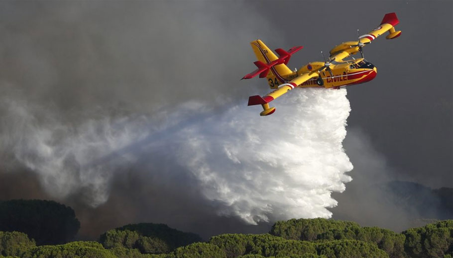 Πυροσβεστικό αεροπλάνο κάνει ρίψη νερού σε δασική πυρκαγιά © EPA/GUILLAUME HORCAJUELO