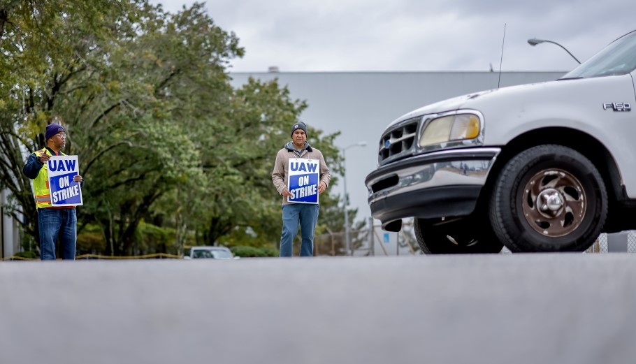 Μέλος του εργατικού συνδικάτου UAW δίπλα σε όχημα της Ford © EPA/ERIK S. LESSER