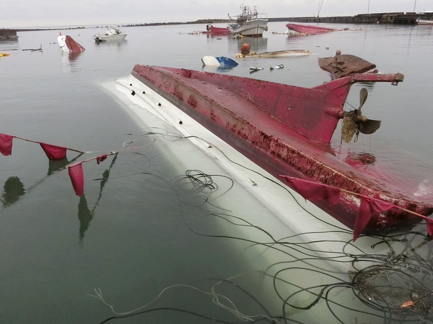 Αναποδογυρισμένες βάρκες μετά από ισχυρό σεισμό σε λιμάνι κεντρική Ιαπωνία © EPA/JIJI PRESS JAPAN